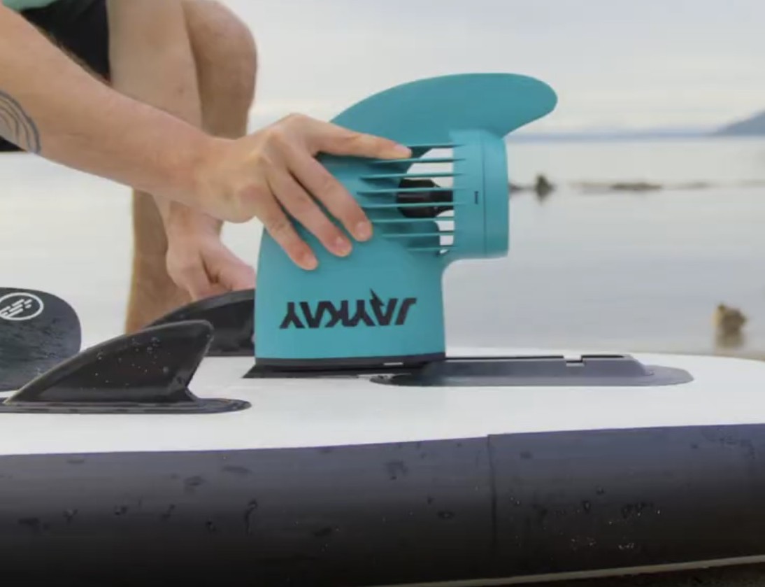 A JayKay electric motor being fitted to a paddleboard
